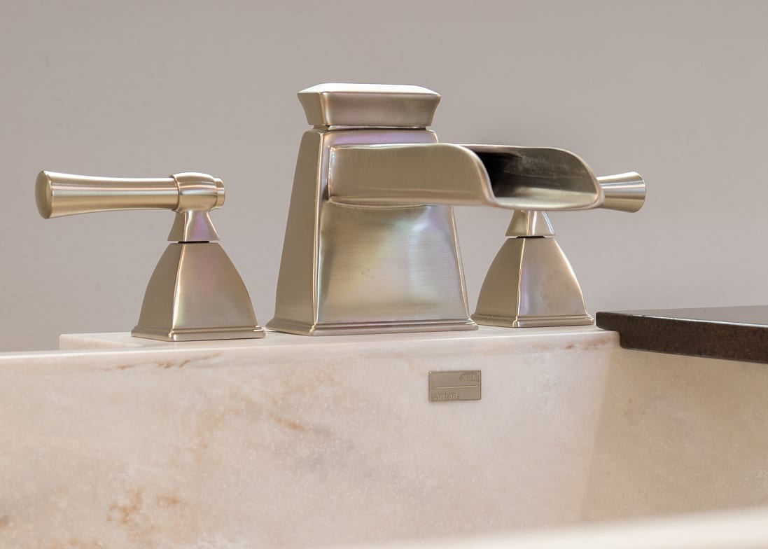 Close-up of sink faucet with Signature Surfaces sink basin
